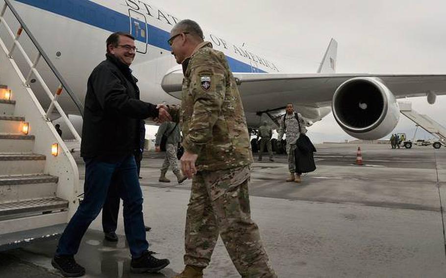 Secretary of Defense Ashton Carter is greeted by Gen. John Campbell as he arrives in Kabul, Afghanistan, on Saturday, Feb. 21, 2015. Carter planned to meet with Afghan leaders and visit deployed U.S. troops during his 1st international trip as defense secretary.