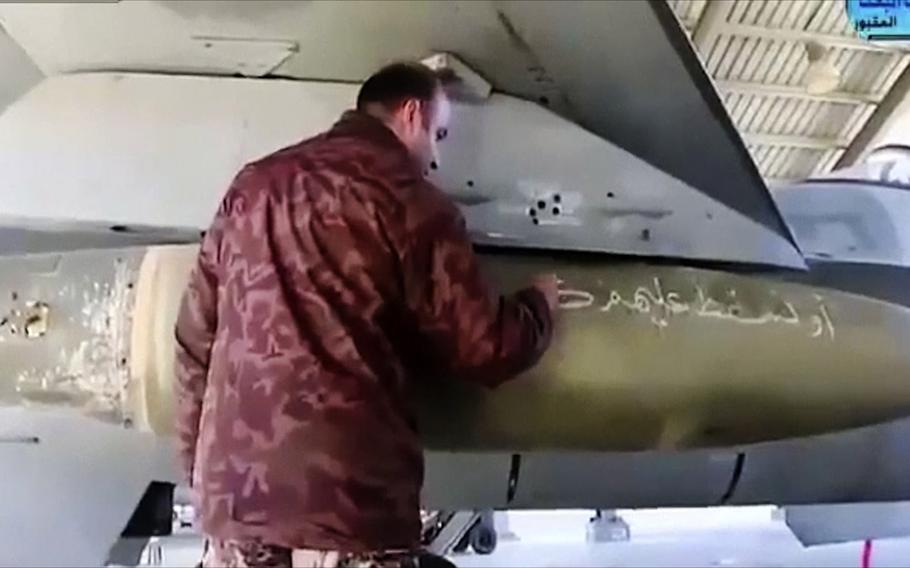 An air force pilot writes a message to Islamic State militants on a missile at Mowafak Al-Salti airbase in Azraq, Jordan, on Feb. 4, 2015. King Abdullah II has thrust Jordan to the center of the war against the Islamic State group with his pledge of relentless retaliation for the killing of one of his pilots. 