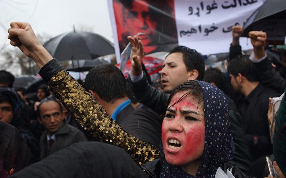 An Afghan protester, her face painted red to resemble a bloodied face, shouts slogans with others during a rally in front of the Supreme Court in Kabul to demand justice for Farkhunda, a woman who was beaten to death by a mob after being falsely accused of burning a Quran in March 2015.
