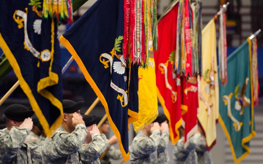 Battalion unit colors from the 1st Brigade Combat Team, 10th Mountain Division are displayed while saluting during a transformation ceremony held at Magrath Sports Complex on Fort Drum Oct. 17, 2014.