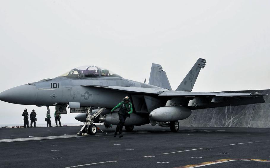 An F/A-18F Super Hornet prepares to launch off the flight deck aboard Nimitz-class aircraft carrier USS Theodore Roosevelt on April 15, 2015. 