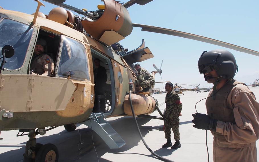 In this file photo from 2014, an Afghan air force crew prepares a Russian-built Mi-17 helicopter for a flight at a military base attached to Kabul International Airport. The tiny Afghan air force had to be built from scratch after the U.S. invasion of Afghanistan in 2001.