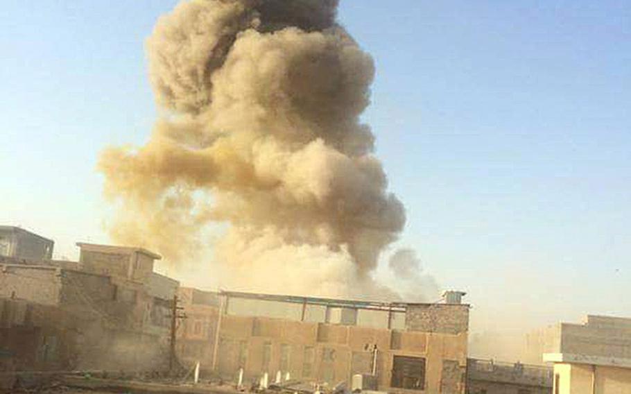 An Islamic State car bomb explodes at the gate of a government building near the provincial governor's compound in Ramadi, Iraq, on Saturday, May 16, 2015, during heavy fighting that saw most of the city fall to the militants.