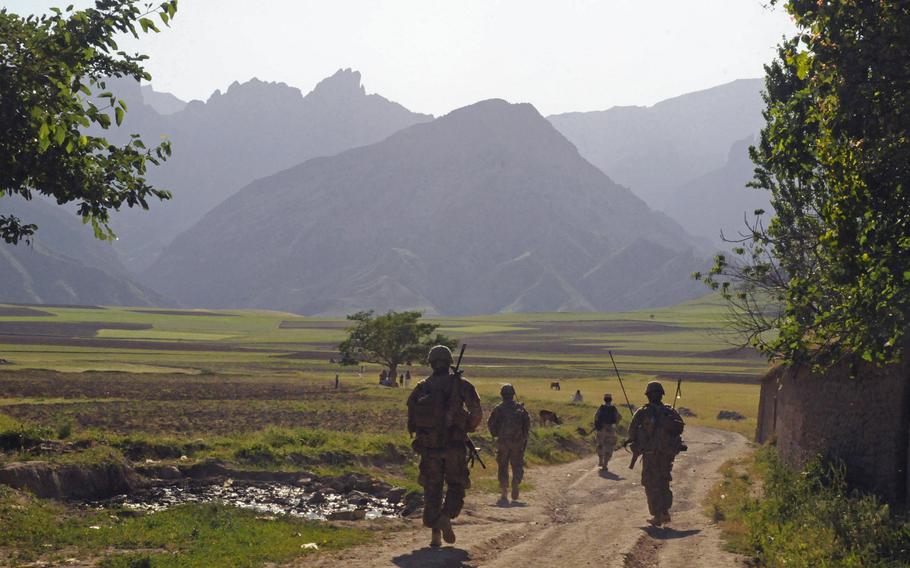 A soldier of the 6th Kandak Afghan Border Police leads soldiers of the 5th Zone Security Force Assistance Team, assigned to the 37th Infantry Brigade Combat Team, down a dirt road in Khwahan, Badakhshan province, Afghanistan, June 3, 2012.
