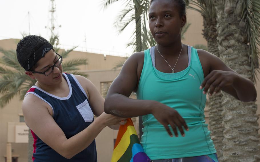 Marine Sgt. Sol Borjas, left, pins a rainbow flag to Marine Sgt. Doris Simmons, right, prior to Naval Support Activity Bahrain's Pride Month three-kilometer race June 17, 2015, in support of the lesbian, gay, bisexual, and transgender community.  

