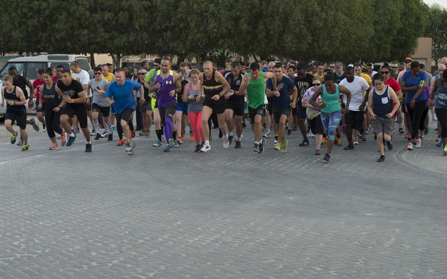 Runners dash off the starting line of Naval Support Activity Bahrain's Pride Month three-kilometer race June 17, 2015, in support of the lesbian, gay, bisexual, and transgender community.  

