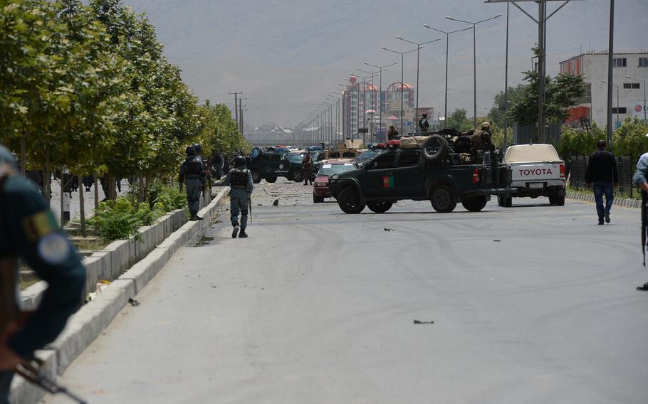 Afghan security forces cordon off the site of a complex attack on the Parliament building in Kabul on Monday, June 22, 2015. The Taliban claimed responsibility for the strike.
