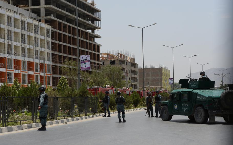 Afghan security forces cordon off a construction site where Taliban insurgents  launched multiple rocket-propelled grenades at the Parliament building during an attack on Monday, June 22, 2015, in Kabul. 

