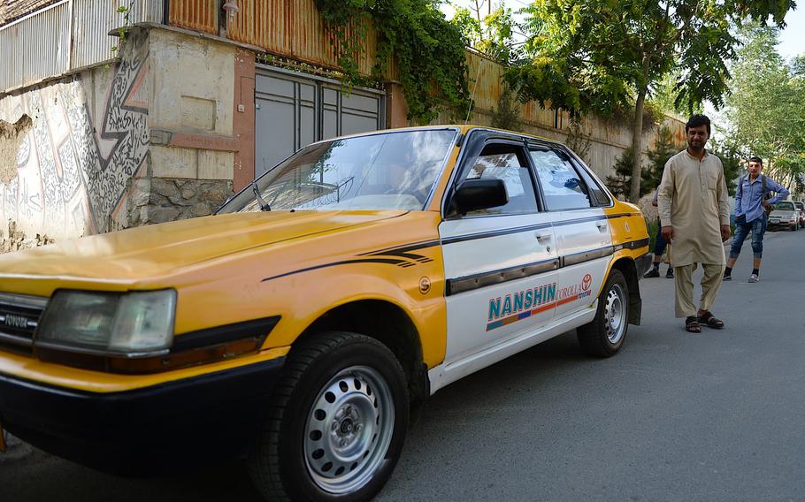 Kabul taxi driver Shir Shah heads for the driver's seat of his 1986 Toyota Corolla in the Tamani neighborhood of central Kabul. Since Toyota introduced the Corolla nearly 40 years ago, it has become the world's best-selling model with more than 40 million cars sold.



