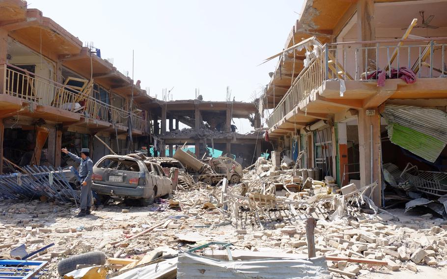 Buildings and cars sit mangled near the site of a large truck bomb that exploded in Kabul on Aug. 7, 2015. The blast left a wide swath of destruction and killed or wounded more than 100 people.

