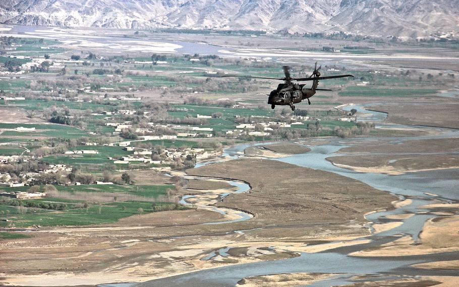 In a March, 2015 file photo, a UH-60 Black Hawk helicopter flies over Afghanistan's Nangarhar province.
