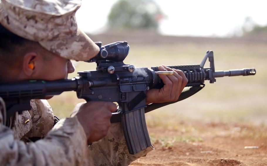 A U.S. Marine takes aim with an M16A4 service rifle at Pu'uloa Rifle Range near Ewa Beach, Hawaii, in September 2013. A government watchdog has asked top U.S. commanders in Afghanistan to explain plans to provide new military equipment, including M16A4 rifles, worth over $630 million to the Afghan security forces, suggesting they may not need it.