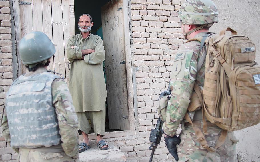 U.S. soldiers speak with a local shopkeeper in Kunduz, Afghanistan on Aug. 15, 2013. According to a report by Amnesty International released on Friday, Oct. 2, 2015, Kunduz residents described how Taliban fighters committed murder, rape, and other abuses after they took control of the city.