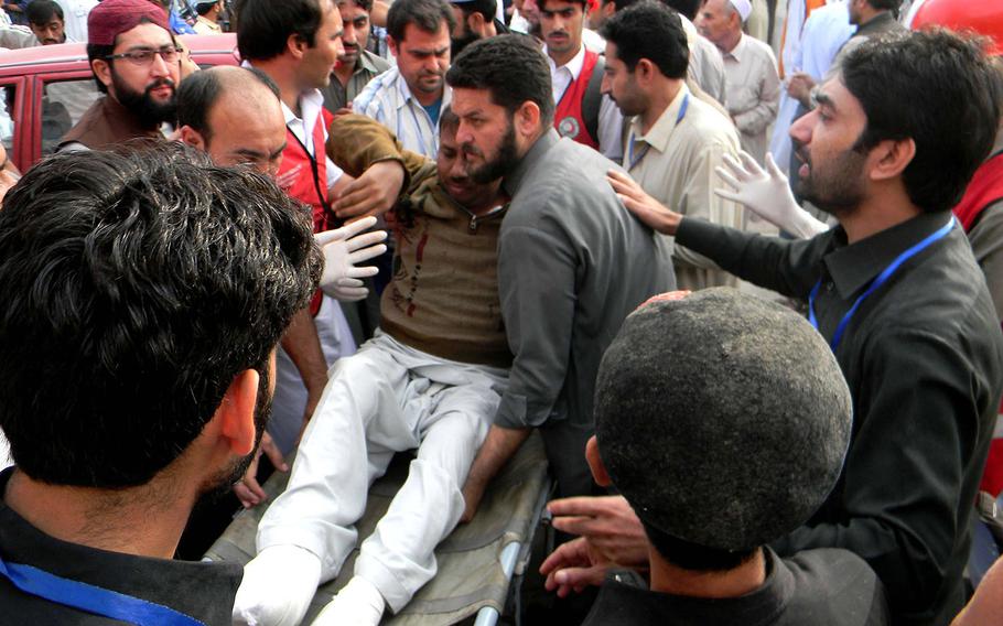 Pakistani people transfer an injured man to a hospital after a severe earthquake on Oct. 26, 2015 in northwest Pakistan's Peshawar. At least 100 people were killed and over 400 others injured when an earthquake measuring 8.1 at Richter Scale hit Pakistan on Monday, local media and met office said. 