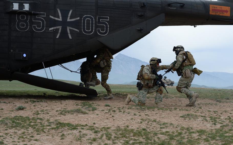 A Georgian soldier provides cover as members of Train, Advise and Assist Command-North's Quick Reaction Force climb aboard a German helicopter during a March 31, 2015, air-assault drill in Afghanistan's Balkh province. 


