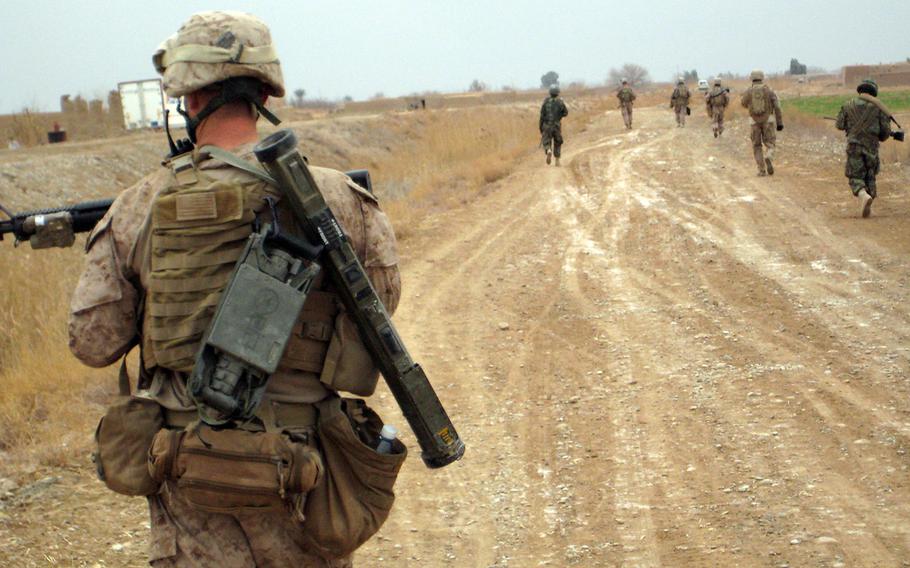 In a 2011 file photo, U.S. Marines patrol the outskirts of Marjah, Helmand province, Afghanistan.