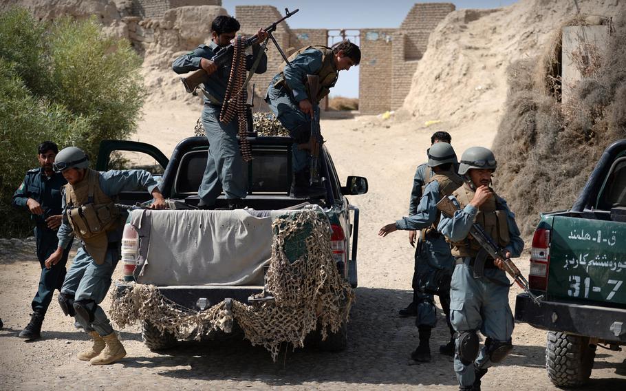 Afghan policemen dismount from a truck during a patrol in Helmand province on Sept. 23, 2014. Afghan security forces have struggled to keep control of Helmand, which is part of the Taliban's spiritual homeland.