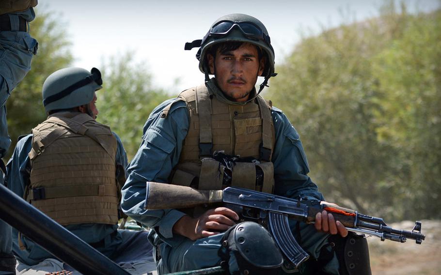 An Afghan policeman rides in the back of a truck during a patrol in Helmand province on Sept. 23, 2014. U.S. special forces have come back to Helmand in early to assist Afghan security forces, who have ceded ground to the Taliban since coalition forces left the province in late 2014.