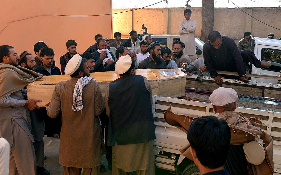 Afghan men in Kunar province, east of Kabul, Afghanistan, carry the coffin of a victim of a deadly suicide attack on Saturday, Feb. 27, 2016. At least 10 civilians were killed when a suicide bomber on a motorcycle targeted a local tribal leader near a park, an Afghan official said.