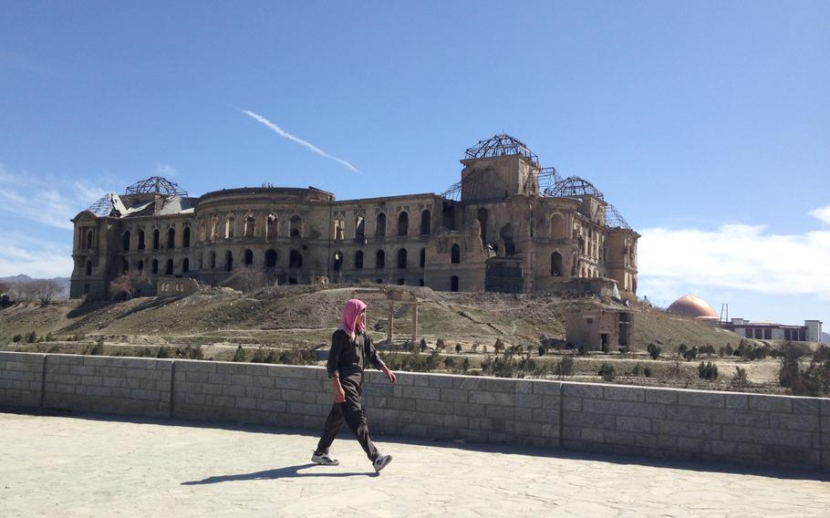 A pedestrian passes the remnants of Kabul's Darul Aman Palace on Sunday, Feb. 28, 2016. The palace, built nearly 100 years ago to house the national parliament, was destroyed in the 1990s during Afghanistan's civil war. It is now set to be restored. In the background is the dome of the new parliament building.


