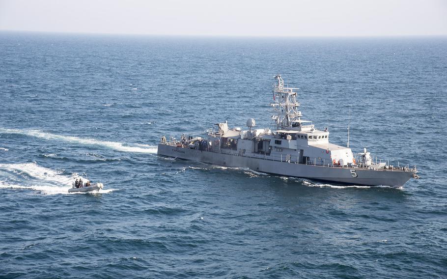 A rigid hull inflatable boat transits alongside the coastal patrol ship USS Typhoon during a vertical onboard deliver exercise in this Feb. 2014 photo.  