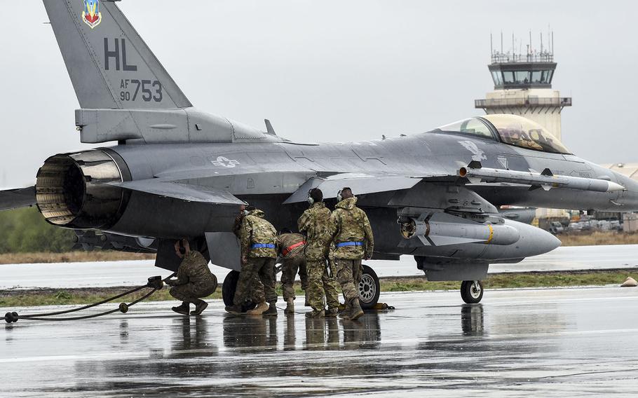 Airmen from the 455th Expeditionary Maintenance Group remove the cable of an aircraft arresting system from an F-16 Fighting Falcon at Bagram Airfield, Afghanistan, March 11, 2016. 