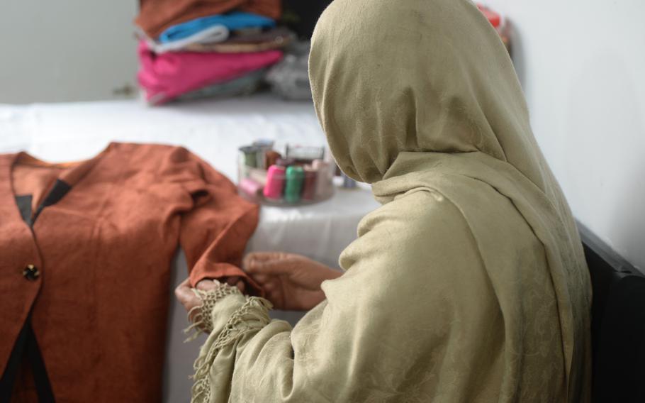 Maryam Habibi sews garments by hand at the Tarsian and Blinkley textiles factory in Kabul on March 23, 2016. She is one of a handful of part-time workers left at the company, which used to employ 1,200 Afghans. 

