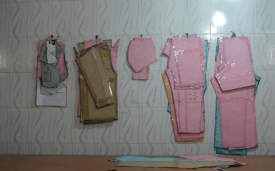 Patterns for Afghan army uniforms hang on the wall at the Tarsian and Blinkley textiles factory in Kabul on March 23, 2016. The U.S. terminated its contract with the company in 2013 and the company has been struggling since. 

