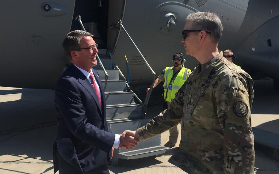Secretary of Defense Ash Carter is greeted by Lt. Gen. Sean MacFarland as he arrives in Baghdad, Monday, April 18, 2016. Carter announced the U.S. will send Apache helicopters and more than 200 additional troops to aid in the fight for Mosul. 