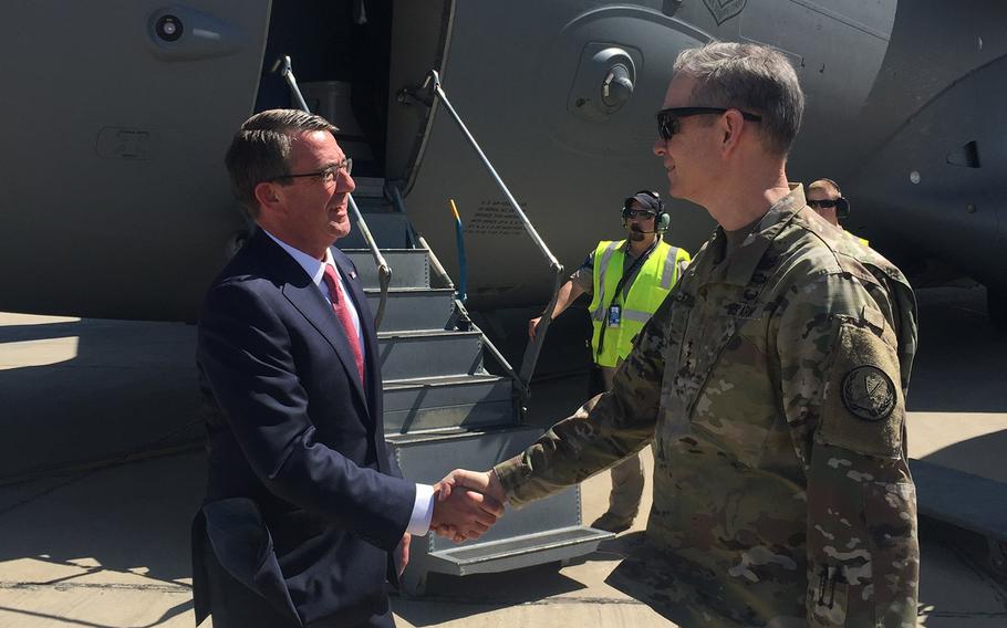 Secretary of Defense Ash Carter is greeted by Lt. Gen. Sean MacFarland as he arrives in Baghdad, Monday, April 18, 2016. Carter announced the U.S. will send Apache helicopters and more than 200 additional troops to aid in the fight for Mosul.