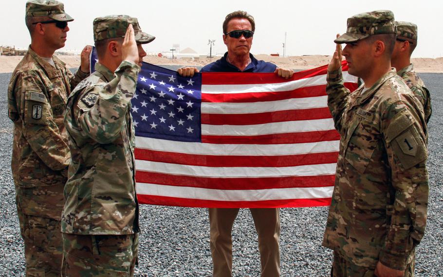 Arnold Schwarzenegger, the former governor of California, observes the Oath of Enlistment ceremony of Spc. James Berg, a wheeled vehicle mechanic with Company B, 299th Brigade Support Battalion, at Camp Buehring, Kuwait, April 28, 2016. Schwarzenegger was in Kuwait to film a National Geographic documentary, "Years of Living Dangerously," focused on climate change. 

