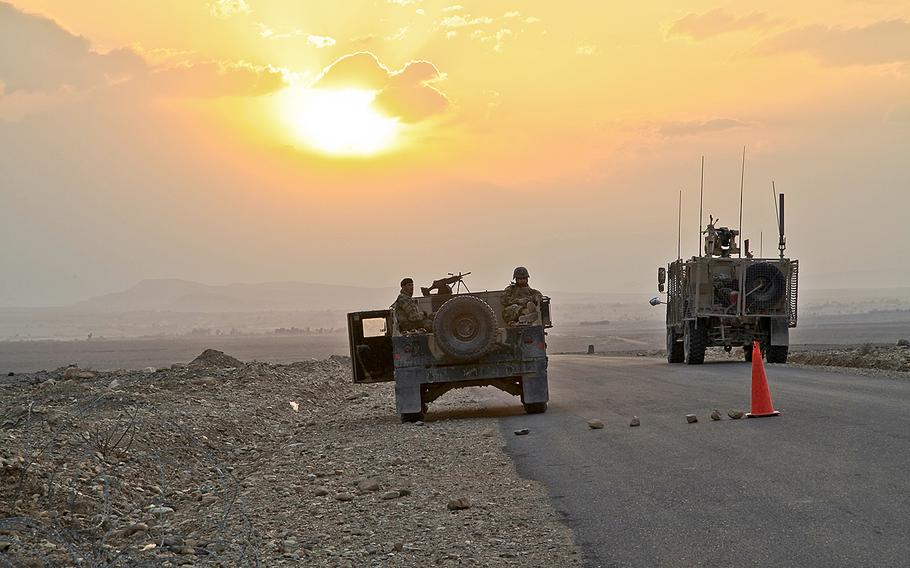 Afghan soldiers provide security outside of a checkpoint, in the Nazyan district in Afghanistan's Nangarhar province, on March 10, 2012. Insurgent attacks in the region on Tuesday, May 10, 2016, have killed at least 11 people, including women in children.