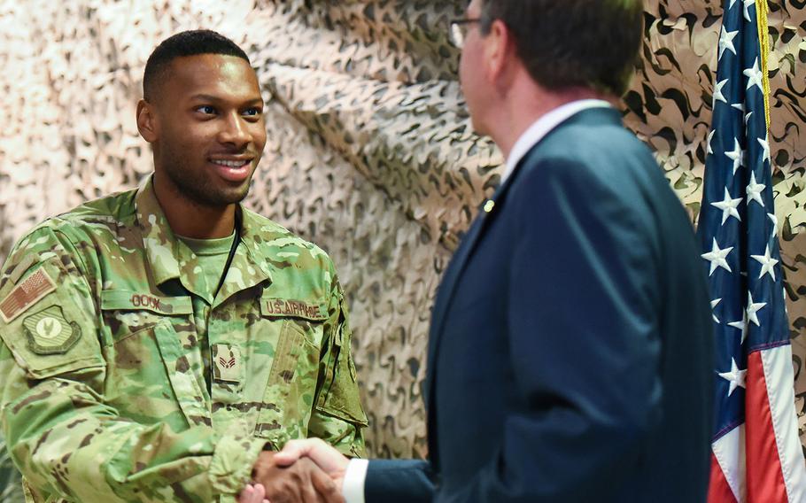 A U.S. Air Force airman shakes hands with Defense Secretary Ash Carter at Baghdad International Airport on Monday, July 11, 2016. Carter visited Iraq to meet with anti-Islamic State group coalition commanders and key Iraqi leaders.