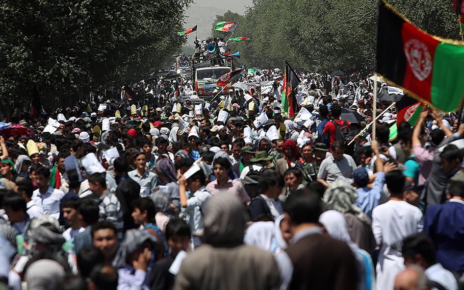 Thousands of demonstrators march towards the center of Kabul, Afghanistan, Saturday, July 23, 2016.