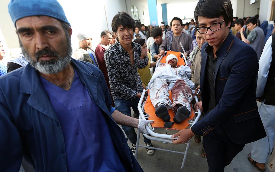 An injured man is taken to a hospital in Kabul, Afghanistan, on Saturday, July 23, 2016, after a deadly explosion struck a protest march by ethnic Hazaras.