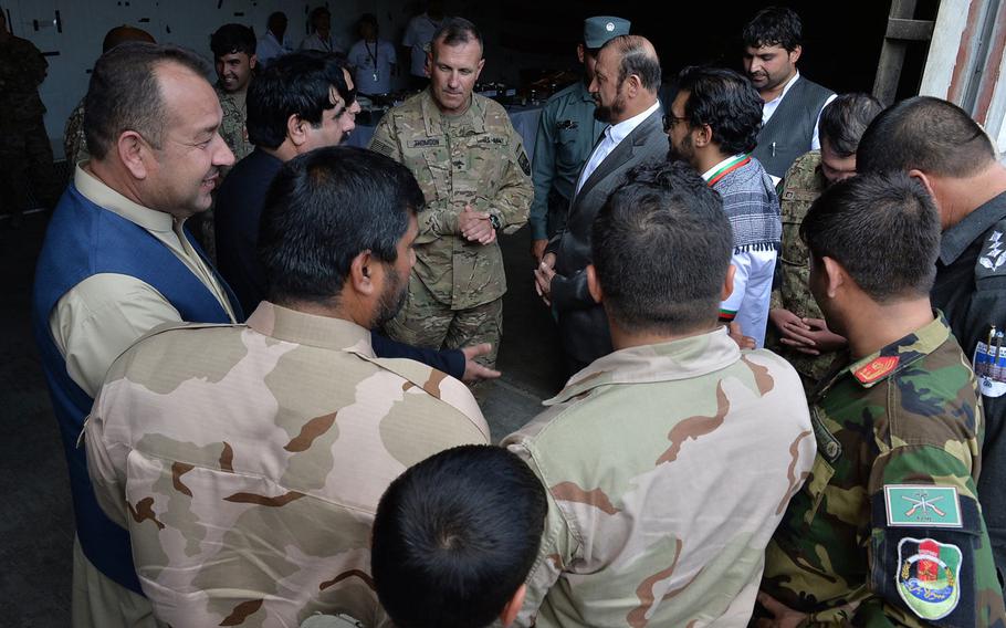 Afghan officials, including the governors of Parwan and Kapisa provinces, greet Maj. Gen. John 'J.T.' Thomson, commander of the U.S. Army's 1st Cavalry Division, after a transfer of authority ceremony at Bagram Air Field on Tuesday, Sept. 13, 2016, in which Thomson took over command of U.S. Forces-Afghanistan's national support element.