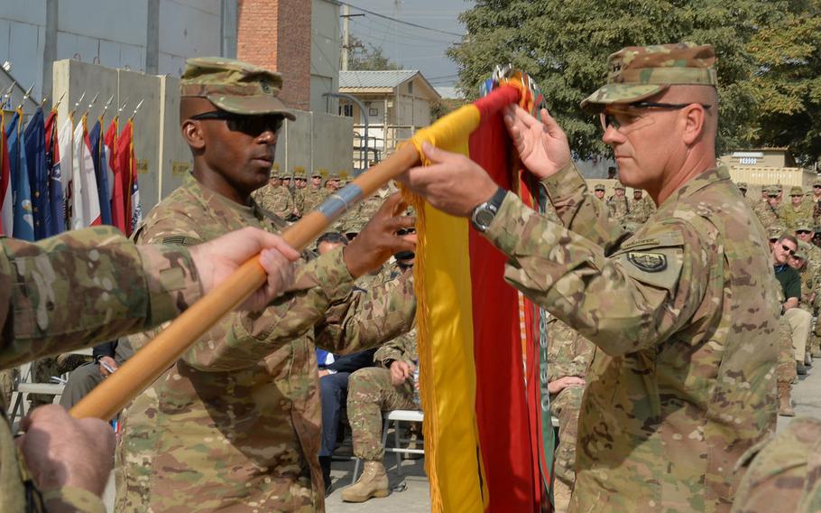 Command Sgt. Maj. Maurice Jackson, left, and Maj. Gen. John 'J.T.' Thomson, right, uncase the 1st Cavalry Division colors at a transfer of authority ceremony for U.S. Forces-Afghanistan's support element at Bagram Air Field on Tuesday, Sept. 13, 2016.