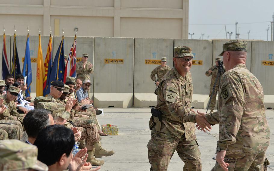 Maj. Gen. John 'J.T.' Thomson shakes hands with Maj. Gen. Jeffrey Bannister during a transfer of authority ceremony at Bagram Air Field on Tuesday, Sept. 13, 2016. Thomson, who leads the U.S. Army's 1st Cavalry Division, assumed command of U.S. Forces-Afghanistan's national support element from Bannister, who leads the Army's 10th Mountain Division.