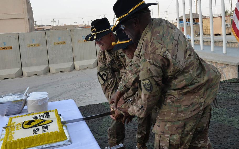 Leaders of the 1st Cavalry Division, from left to right, Maj. Gen. John 'J.T.' Thomson, Sgt. Maj. Francisco Acosta and Command Sgt. Maj. Maurice Jackson, cut the division's 95th birthday cake with a cavalry saber during a ceremony on Tuesday, Sept. 13, 2016 at Bagram Air Field. 


