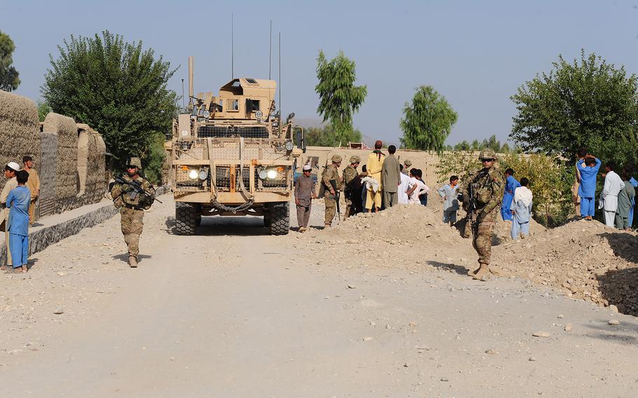 U.S. troops patrol while others speak with locals near Lalmah village, Chapahar district, Nangarhar province, Afghanistan, on Sept. 1, 2013. Two U.S. servicemembers were wounded Saturday, Oct. 8, 2016, near Chapahar district during a routine security patrol in the vicinity of Jalalabad Airfield.