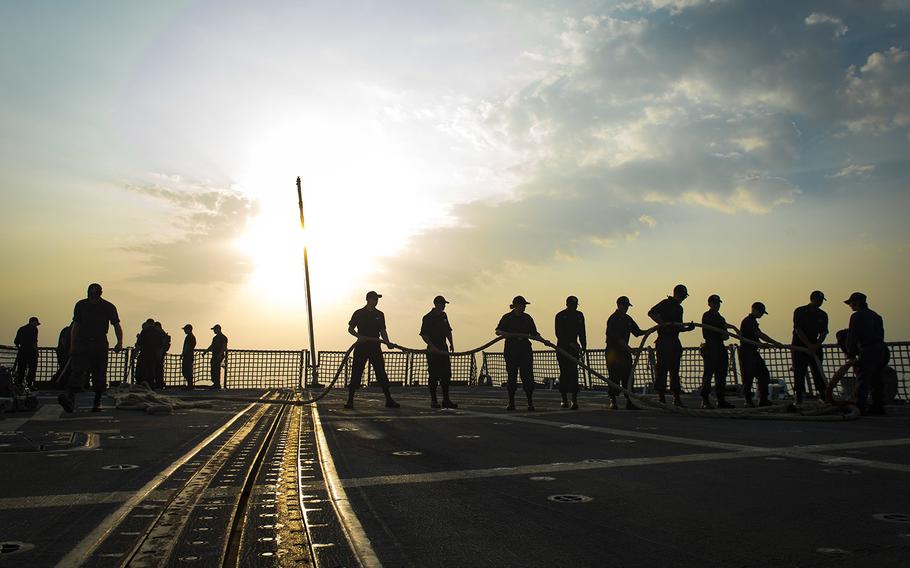 Sailors assigned to the guided-missile destroyer USS Nitze participate in sea and anchor detail following a port visit at Manama, Bahrain. 