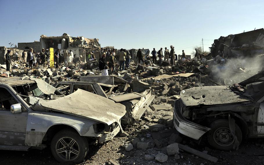 People gather at the bombed site near an air force base to search for casualties in Sanaa, Yemen, on Thursday, March 26, 2015.