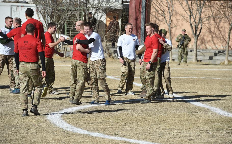 British and German troops congratulate each other following a Christmas Day soccer match Sunday at Resolute Support headquarters in Kabul commemorating the 1914 Christmas Truce.