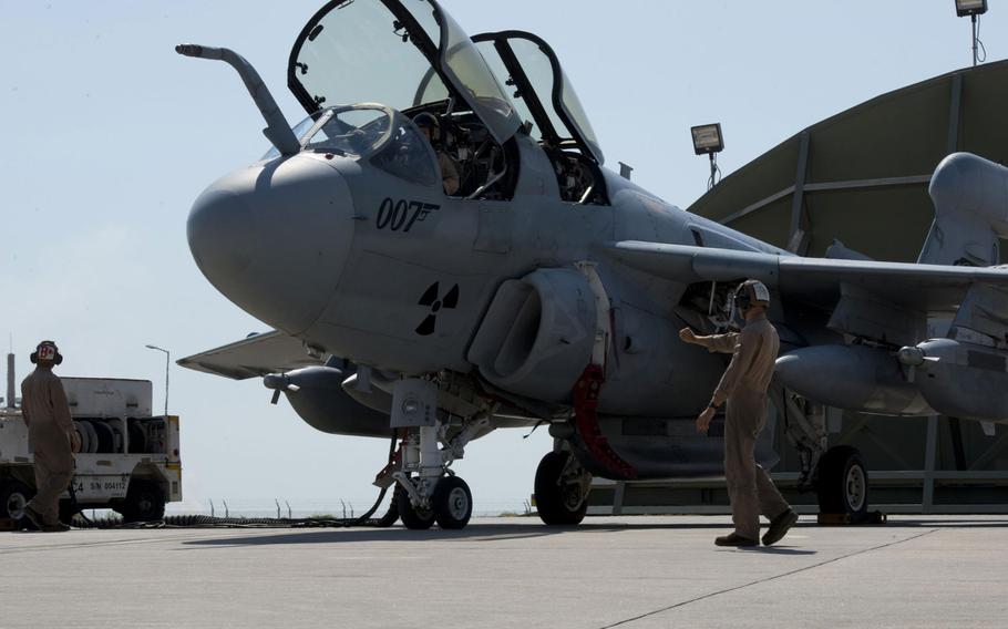 U.S. Marine Corps Cpl. Kogut Bradley, Tactical Electronic Warfare Squadron 4 plane captain, signals for pre-engine start-up, Sept. 16, 2016, at Incirlik Air Base, Turkey.