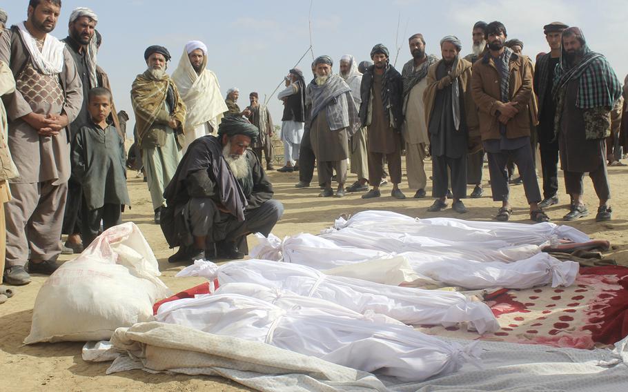 Afghan villagers gather around the bodies of civilians who were killed during clashes between Taliban and Afghan security forces in the Taliban-controlled, Buz-e Kandahari village in Kunduz province, Afghanistan, on Nov. 4, 2016.