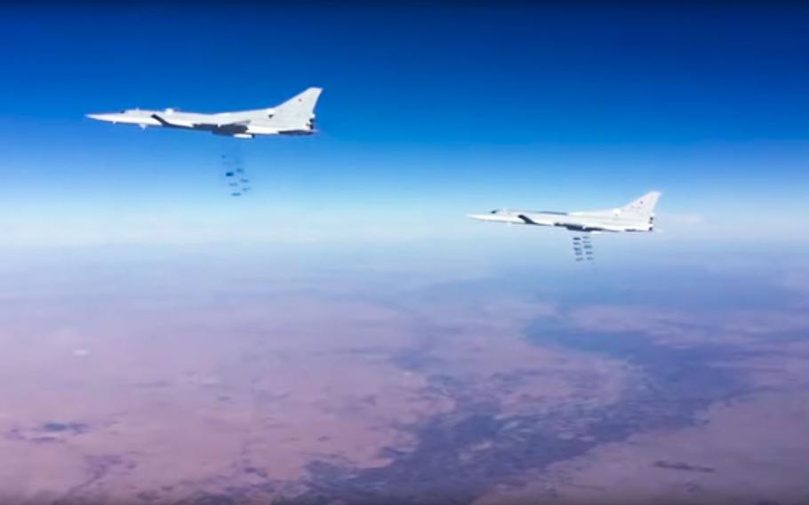 This photo provided by the Russian Defense Ministry Press Service shows Russian air force Tu-22M3 bombers strike Islamic State group targets in Syria on Tuesday, Jan. 24, 2017. 