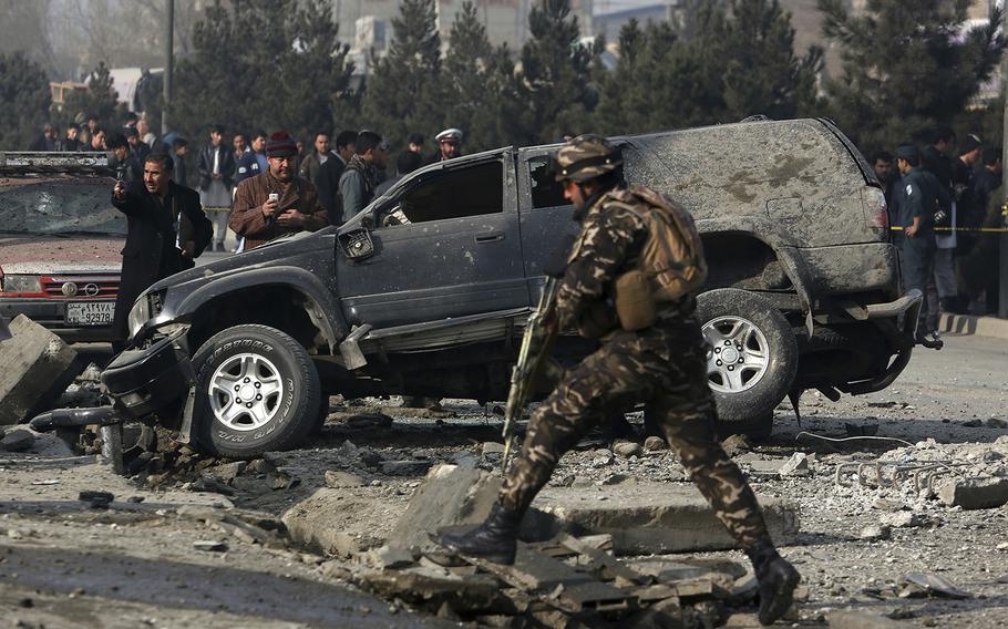 Afghan security personnel inspect the site of a roadside bomb blast in Kabul, Afghanistan, Wednesday, Dec. 28, 2016. A U.N. report released Monday said that a record number of civilians were injured or killed in 2016 in the war in Afghanistan.