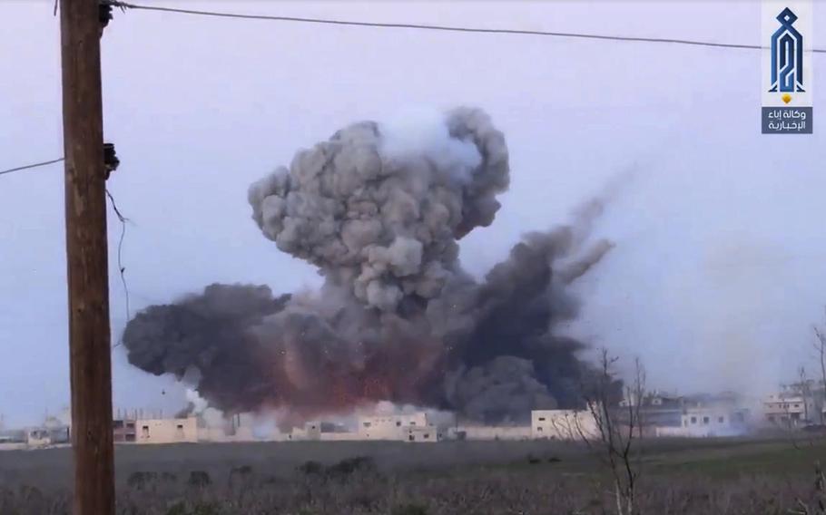 A screen grab from a video posted March 22, 2017, shows black smoke rising after a suicide bomber from the militant group of Levant Liberation Committee, attacked a Syrian government forces position, in Souran Town, northern Hama, Syria. 