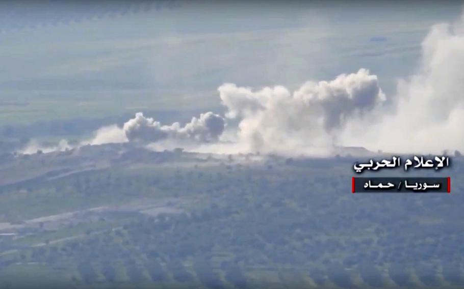 In this Friday, March 30, 2017 frame grab from video provided by the government-controlled Syrian Central Military Media, shows smoke rise from the government forces shelling at insurgent groups position, in Hama, north Syria. 