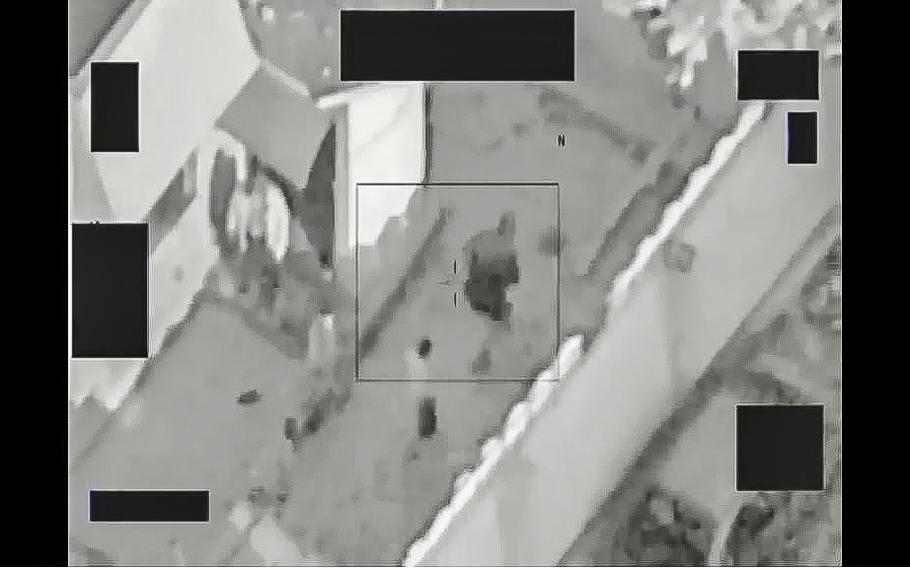 A video screen grab shows civilians be escorted through a compound as Islamic State fighters establish fighting positions.
